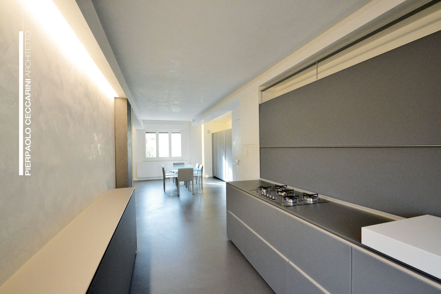 Moderne Küche mit fugenloser Oberfläche, hellem Raum und eleganten Möbeln.